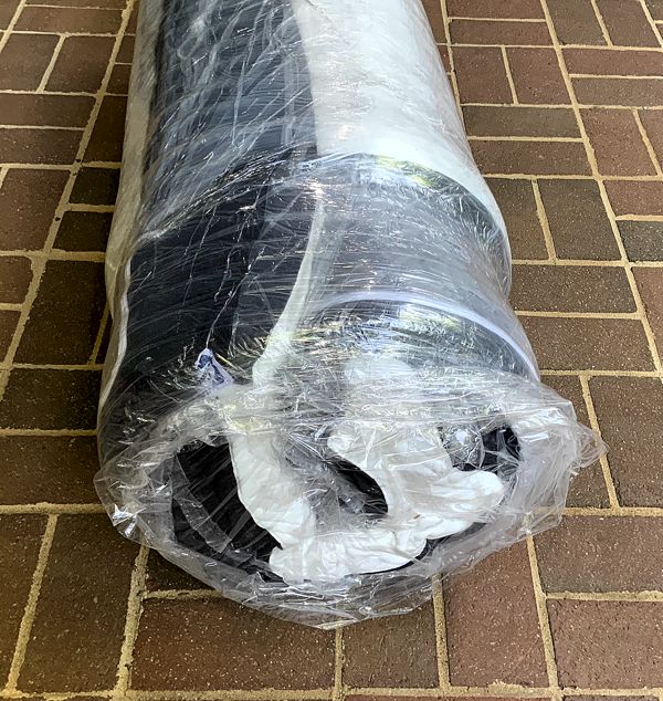 sealy_hybrid_bed_in_box_delivery_roll